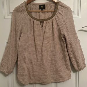 A pretty metallic ribbon adds shine and elevated finish to this top.